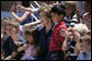 Mrs. Laura Bush sits with children of employees and staff at the U.S. Embassy Monday, in Sofia, Bulgaria, the last stop on a weeklong European visit by she and President George W. Bush. White House photo by Shealah Craighead