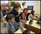 Mrs. Laura Bush joins youngsters at the opening of the American Children's Corner at Sofia City Library Monday, June 11, 2007, in Sofia. Mrs. Bush said, "The books in this American Corner tell the story of the United States, describing my country's history, culture and diverse society. In these books, children in Sofia can discover literature that children in the United States enjoy." White House photo by Shealah Craighead