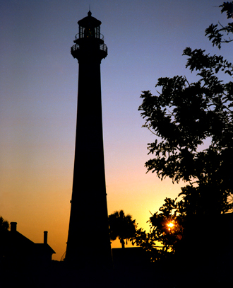 The sun rises behind the Cape Canaveral Lighthouse.