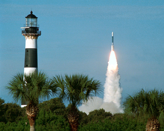 A rocket lifts off near the lighthouse on Cape Canaveral.