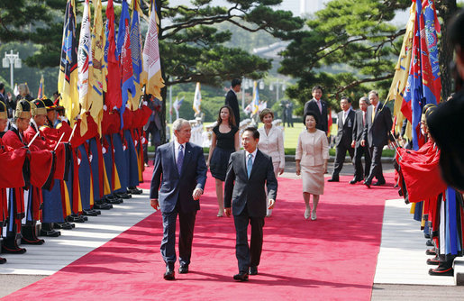 President George W. Bush and South Korean President President Lee Myung-bak, joined by Mrs. Laura Bush, Mrs. Kim Yoon-ok, and daughter Ms. Barbara Bush, participate in a welcoming ceremony in the Grand Garden of the Blue House Wednesday, Aug. 6, 2008, in Seoul. White House photo by Eric Draper