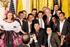 President George W. Bush poses for photos with entertainers Jorge Celedon, Jimmy Zambrano and their performance group during the celebration of Colombian Independence Day Tuesday, July 22, 2008, in the East Room of the White House. White House photo by Eric Draper.