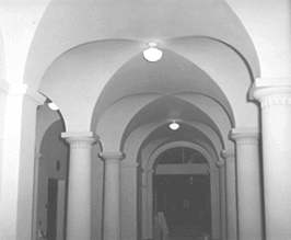 black and white photo of corridor with groin vaulting