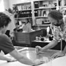 Bruce Nauman in the curating room canceling a copperplate by drawing a sharp tool across it to destroy the image, with assistance from William B, Padien, 1983