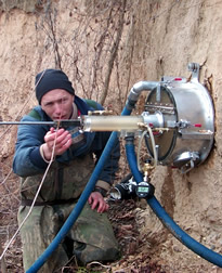 Photo: ARS hydraulic engineer Gregory J. Hanson using the Jet Test apparatus in the field.