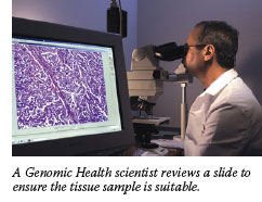 A Genomic Health scientist reviews a slide to ensure the tissue sample is suitable.
