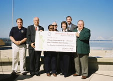 EDA joins Illinois State officials in holding check. Pictured (L-R):  Alan Dunstan, Chairman, Madison County Board; Louanner Peters, Deputy Governor, State of Illinois; Len DeCarlo, External Affairs Officer, FEMA; Kelly O’Brien, Director of Public Affairs; Josh Weger, Managing Director, Office of Policy Development, Planning and Research, Illinois Department of Commerce and Economic Opportunity; Don Sandidge, Mayor, City of Alton.  Click here for larger image.