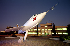 X-1E aircraft in front of Dryden's main building at night.