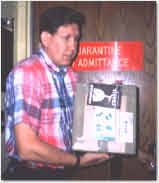 Photo of man holding box near quarantine door