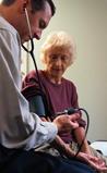 Photo of a woman having her blood pressure taken. - Click to enlarge in new window.