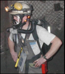 Miner wearing respirator