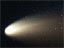 A bright white comet streaks across a black sky