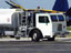 A large fuel truck in front of an aircraft