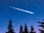 Image of a meteor streaking through the night sky