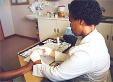 Photo of a nurse taking a blood sample at a voluntary counseling and testing center.