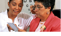 Elderly women undergoing an eye exam by an optician.