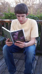 young man reading Selected Rare Plants of Northern California.