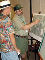 uniformed Forest Service representative discussing a recreation project with a citizen.