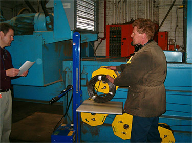 Figure 2: Employee replacing baler wire spool