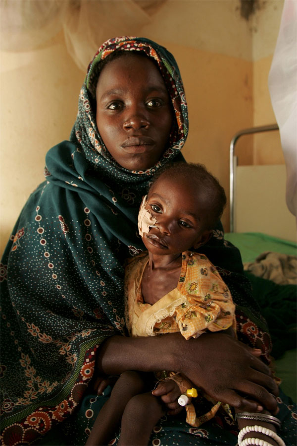 A mother holds her child who gets treatment in the hospital of El Fasher in western Sudan. AP/Wide World Photo.