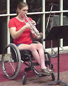 young woman in wheelchair playing trumpet