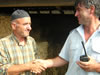 Firefighter Tane Gorgovski (right) shakes hands with Rizvan Memedovski whose farm was saved thanks to the quick response of the Krivogashtani volunteer fire department