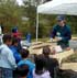 Photo of man talking to children