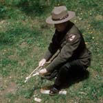 A ranger shows how to spark a fire.