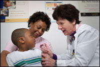 Photo: A healthcare professional with a mother and son.