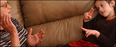 Photo: A woman and child speaking in sign language.