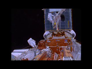 <b>37. HST Archival Film Highlights: Servicing Mission 1 Highlights (SM1): </b> Highlights from upconverted 16mm film B-roll of Servicing Mission 1 (SM1). Includes crew training, EVA highlights, HST deployment, MOCR activities and COR activities, Corrective Optics Space Telescope Axial Replacement (COSTAR) installation to counter effects of the flawed shape of the mirror; solar array jettison and more. NOTE: approximately 5-hours of 16mm film related to Hubble missions is now available in high definition. Contact the Public Affairs Officers for more information.