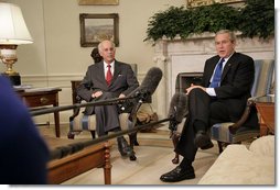 President George W. Bush and Andrew Natsios, Presidential Special Envoy for Sudan, meet with the press in the Oval Office Tuesday, Oct. 31, 2006. White House photo by Kimberlee Hewitt