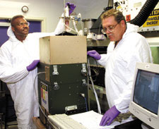  Roosevelt Meriweather and Rob Smith check the operation of the chemical biological mass spectrometer developed partly by ORNL researchers to help U.S. Army soldiers detect chemical and biological warfare weapons.