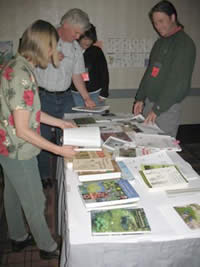 students at the ESRU training session looking at publications spread out on a table.