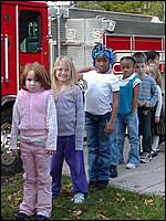Photo: Children by a Fire Truck.