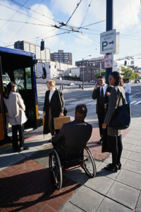 Picture of a group of people waiting at a bus stop