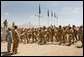 Mrs. Laura Bush is greeted Sunday, June 8, 2008, by New Zealand troops performing a traditional warrior dance at the Bamiyan Provincial Reconstruction Team Base in Afghanistan’s Bamiyan province. Standing with her is Major Justin de la Haye. White House photo by Shealah Craighead