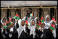 Future students of the Ayenda Learning Center wave flags and greet Mrs. Laura Bush during her visit to the construction site of the Ayenda Learning Center Sunday, June 8, 2008, in Bamiyan, Afghanistan. White House photo by Shealah Craighead