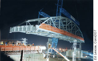 At 2:30 a.m., the 762-metric ton (840-ton) span is lowered into place over the main rail line at New Haven. Busy commuter trains ran under the bridge just hours later.