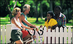 Photo: Two couples talking by a fence