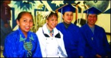 Photo of four recent graduates