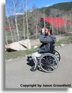 Man in wheelchair with viewing wildlife