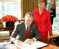 Image of Mrs. Laura Bush with President George W. Bush at the 2005 proclamation signing.