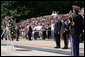 Pausing for a moment of silence, President George W. Bush is accompanied by Major General Richard J. Rowe Jr., commander of the Military District of Washington, right, after laying a wreath at the Tomb of the Unknowns Monday, May 26, 2008, during a Memorial Day ceremony at Arlington National Cemetery in Arlington, VA. White House photo by Chris Greenberg