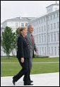 President George W. Bush walks with Germany's Chancellor Angela Merkel as the two leaders met for lunch Wednesday, June 6, 2007, at the Kempinski Grand Hotel in Heiligendamm, Germany.  White House photo by Eric Draper