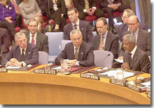 Secretary of State Colin Powell makes a presentation to the UN Security Council while Secretary-General Kofi Annan and UK Foreign Secretary Jack Straw look on.