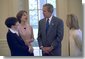 President George W. Bush meets with Sarah Hughes, Olympic gold medalist and figure skater (center, left), her mother, Amy Hughes (far left), and her coach Robin Wagner in the Oval Office Friday, April 12, 2002. White House photo by Eric Draper.