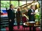 After signing a condolence book for the victims of the recently attacked school in Beslan, Russia, President George W. Bush addresses the media as Ambassador Yuri Ushakov, far left, Laura Bush, and the Ambassador's wife, Svetlana Ushakova, listen at the Russian Embassy in Washington, D.C., Sept. 12, 2004. "I'm here to express my country's heart-felt sympathies for the victims and the families who suffered at the hands of the evil terrorists. The United States stands side-by-side with Russia as we fight off terrorism, as we stand shoulder-to-shoulder to make the world a more peaceful place and a free place," said President Bush.  White House photo by Paul Morse