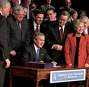 Signing the Medicare Prescription Drug, Improvement, and Modernization Act of 2003, at DAR Constitution Hall in Washington, DC, December 8.