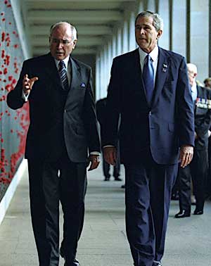 Walking with Prime Minister John Howard of Australia at the Australian War Memorial in Canberra, October 23.